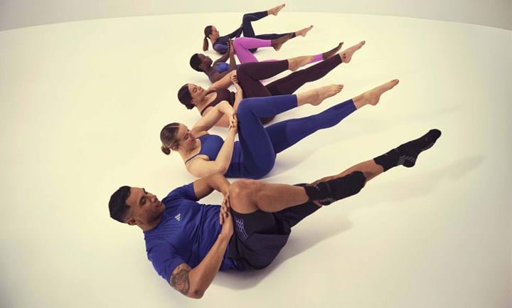 group of people preforming Pilates