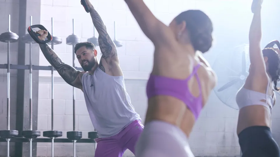 a group of people stretching holding smartbar plates