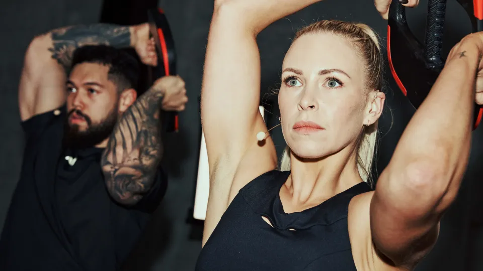 Two Les Mills Instructor lifting a smartbar plate