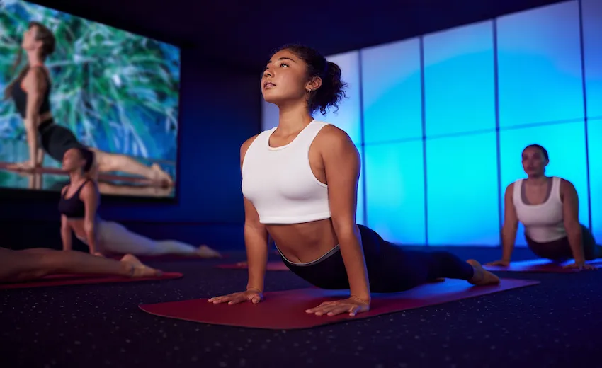 People on yoga mats in upward-facing dog pose